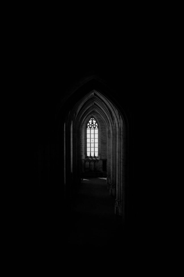 monochrome photo of dark hallway